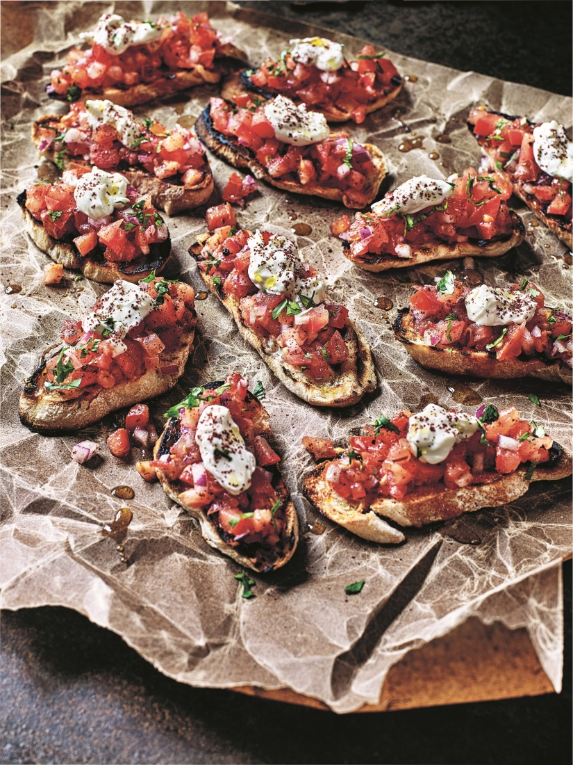 SABRINA GHAYOUR’S SUMAC, TOMATO & GARLIC TOASTS WITH LABNEH